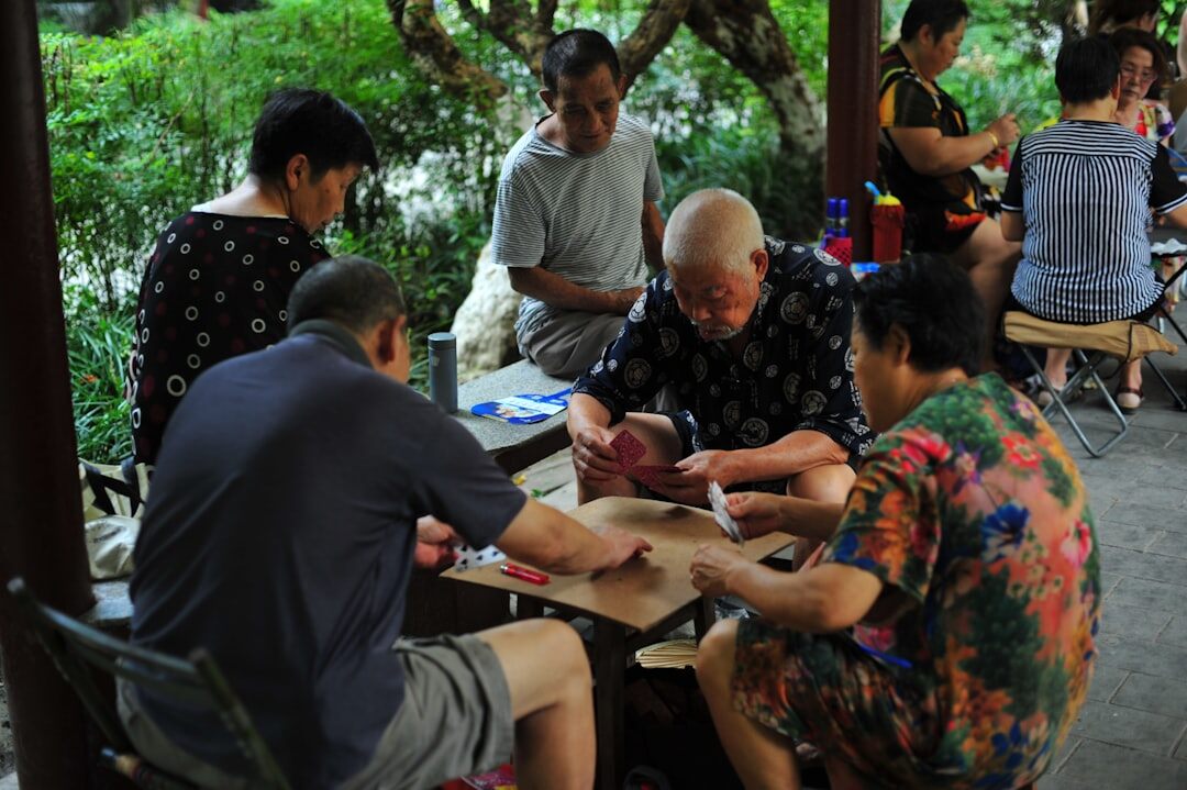 Seniors painting together in a bright community workshop room
