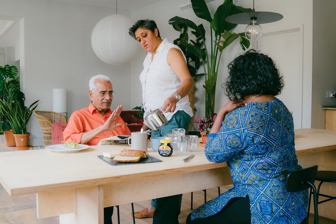 Seniors enjoying tea and conversation together around a table